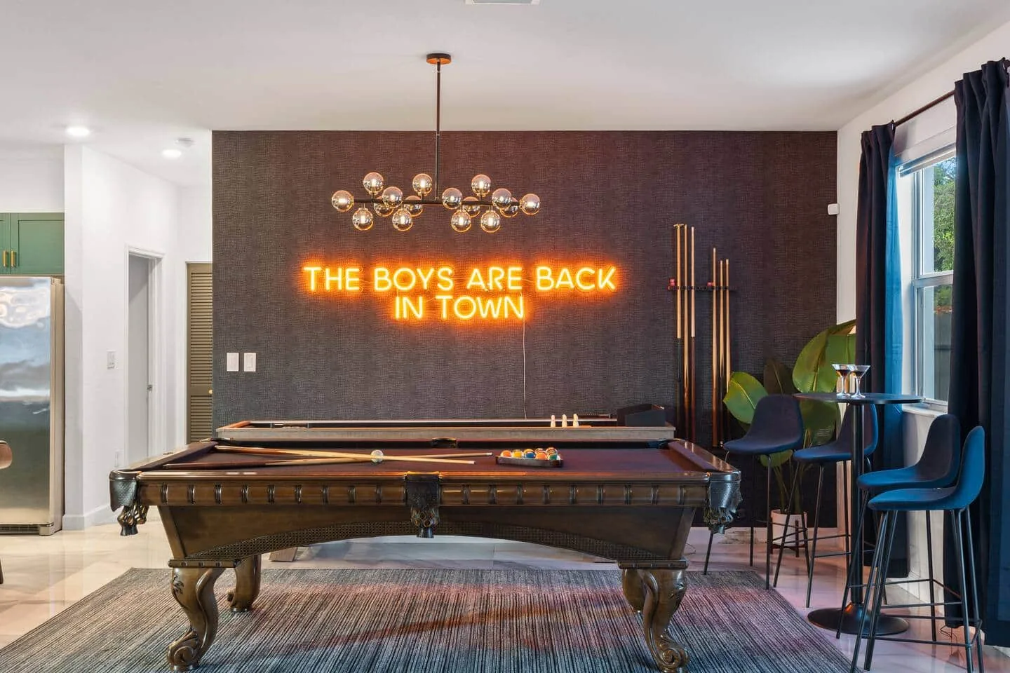 Game room with 9-ft pool table and neon sign