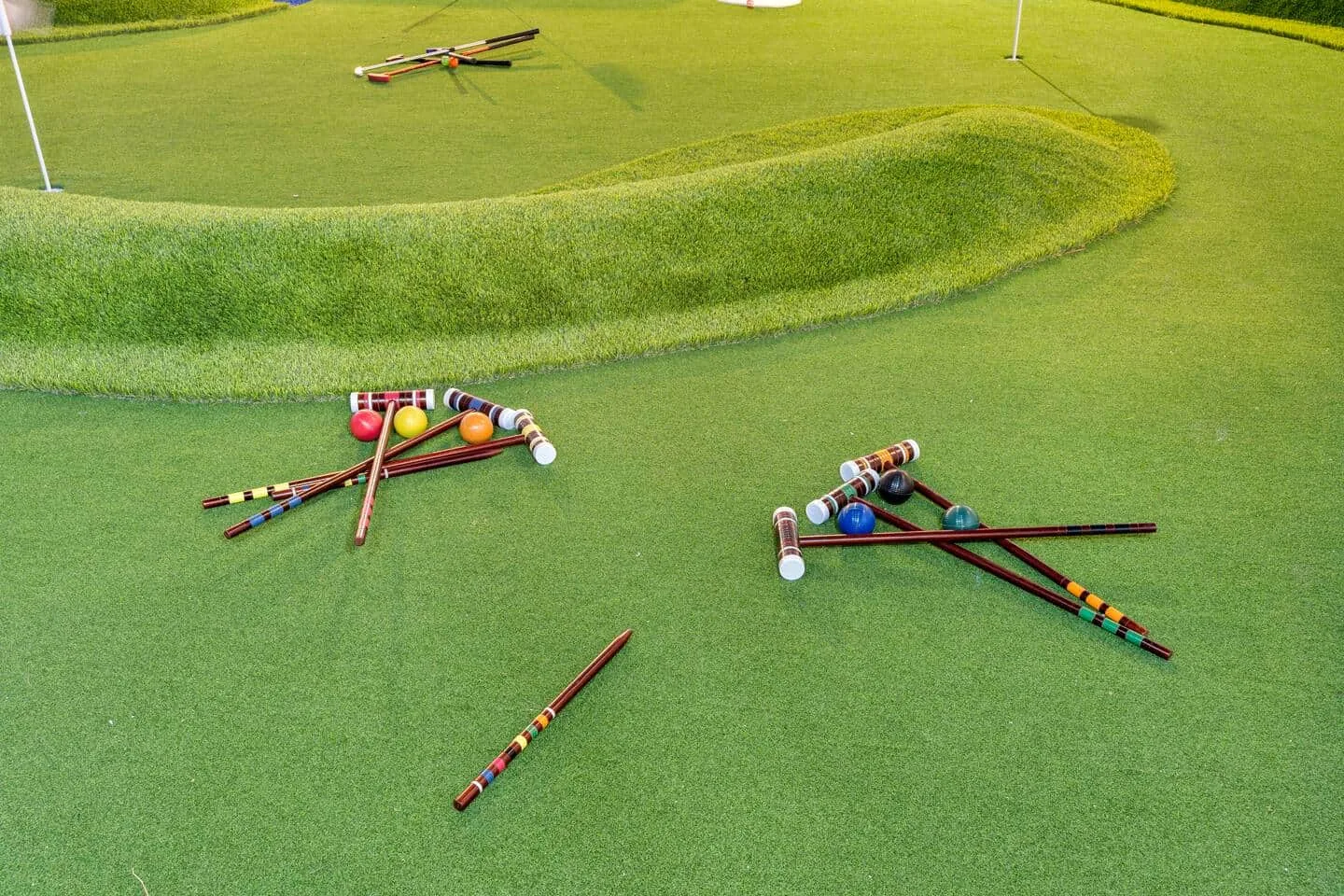Putters and balls on the mini golf green