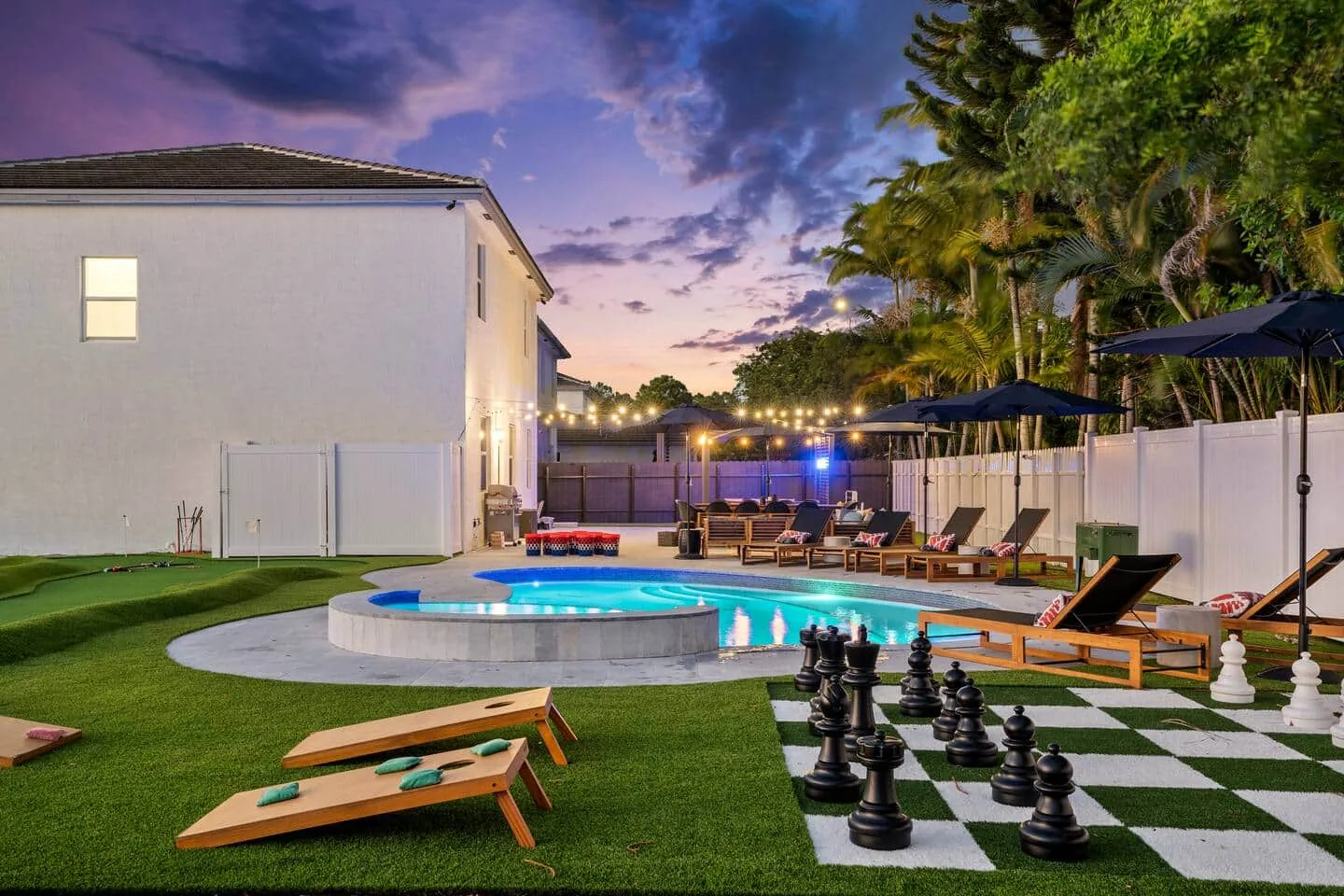 Jacuzzi and pool at dusk with the giant chess board behind