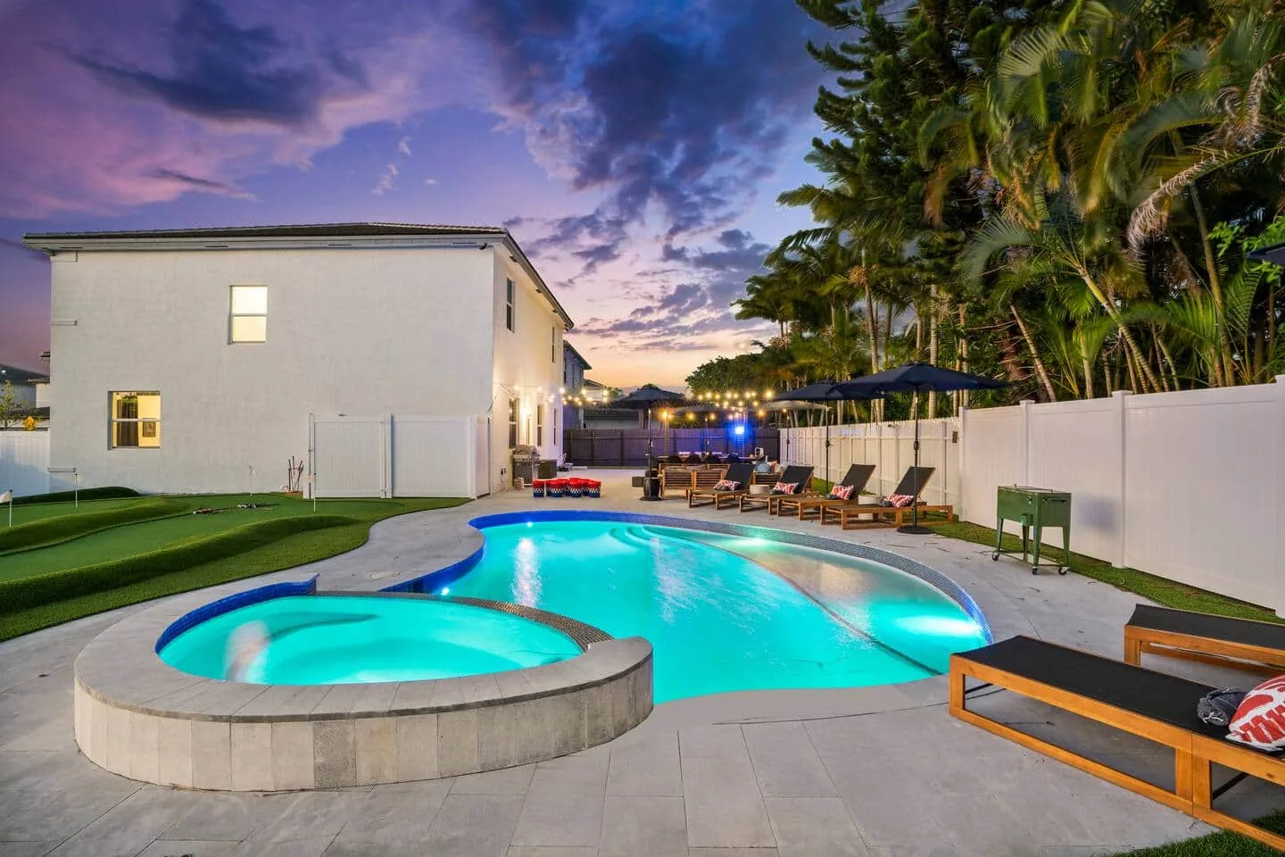 Heated saltwater pool and jacuzzi at twilight